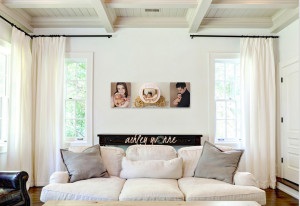 three medium canvas above white couch