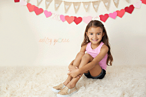 little girl sitting down for photos