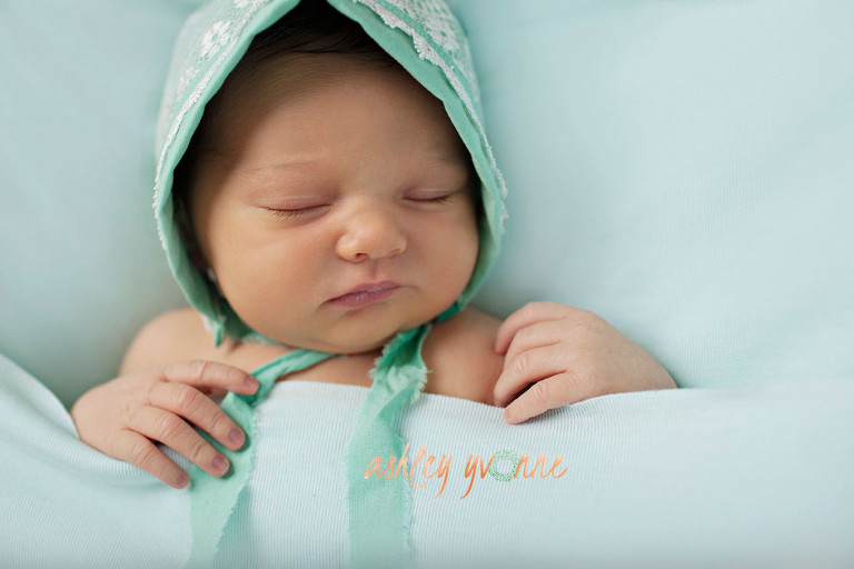 infant girl in green bonnet