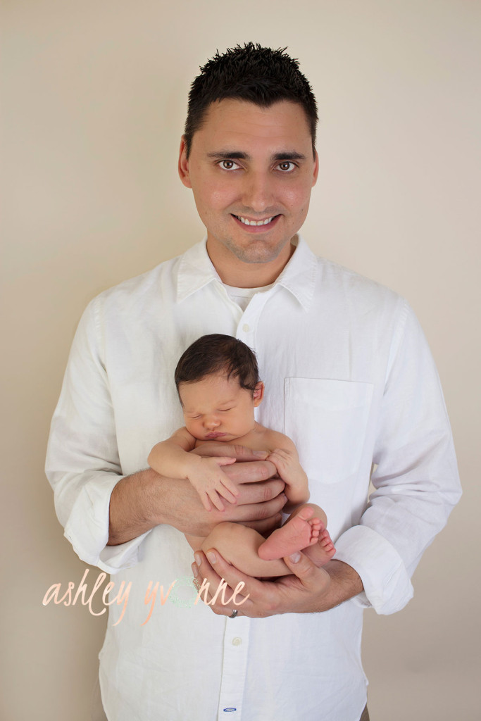 dad holding newborn daughter