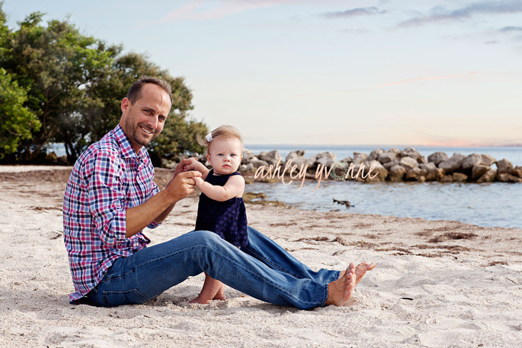 dad and 10 month old girl on beach